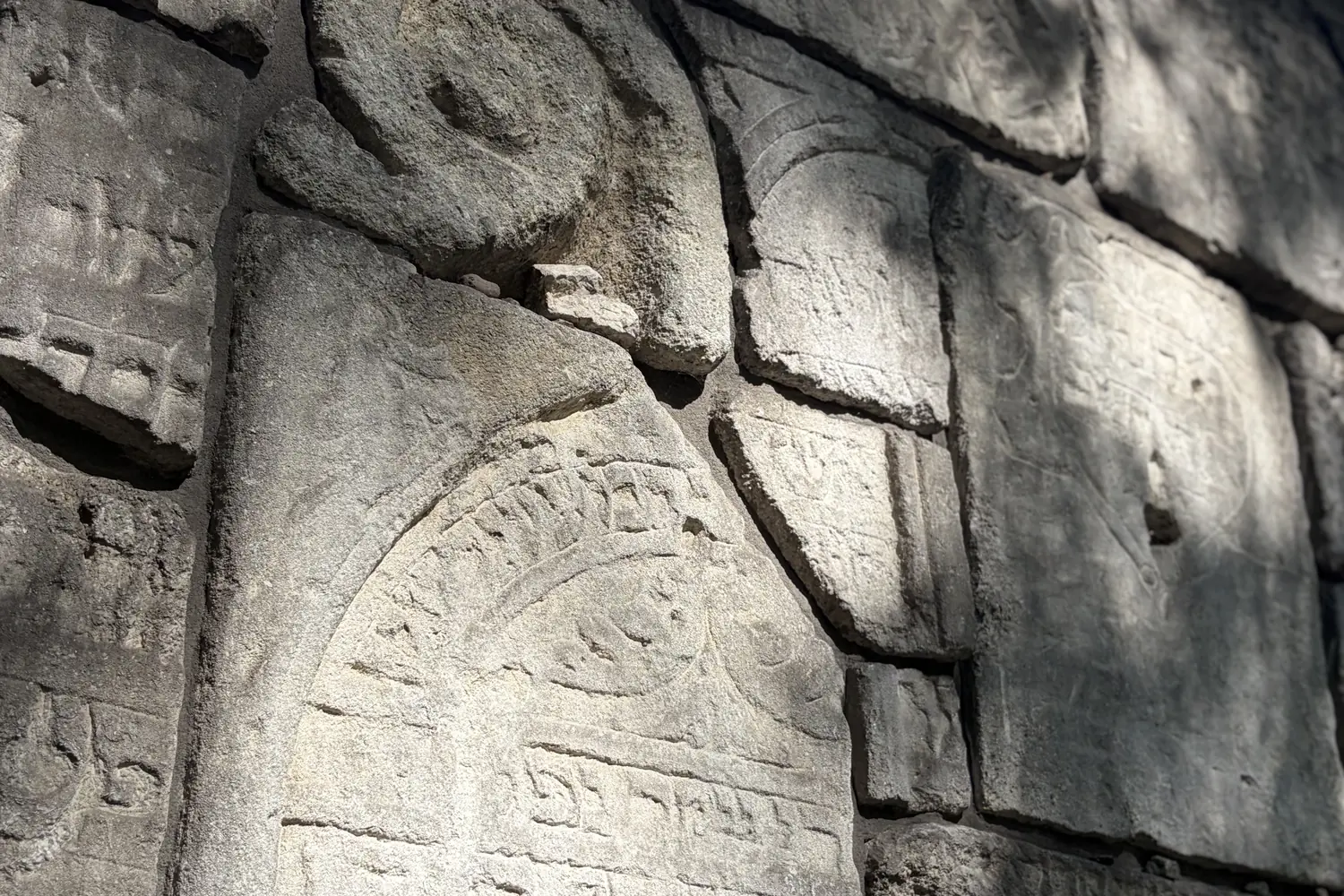 Fragments of matzevot with a volute and Hebrew inscription in the Wailing Wall at the Remah Cemetery in Kazimierz