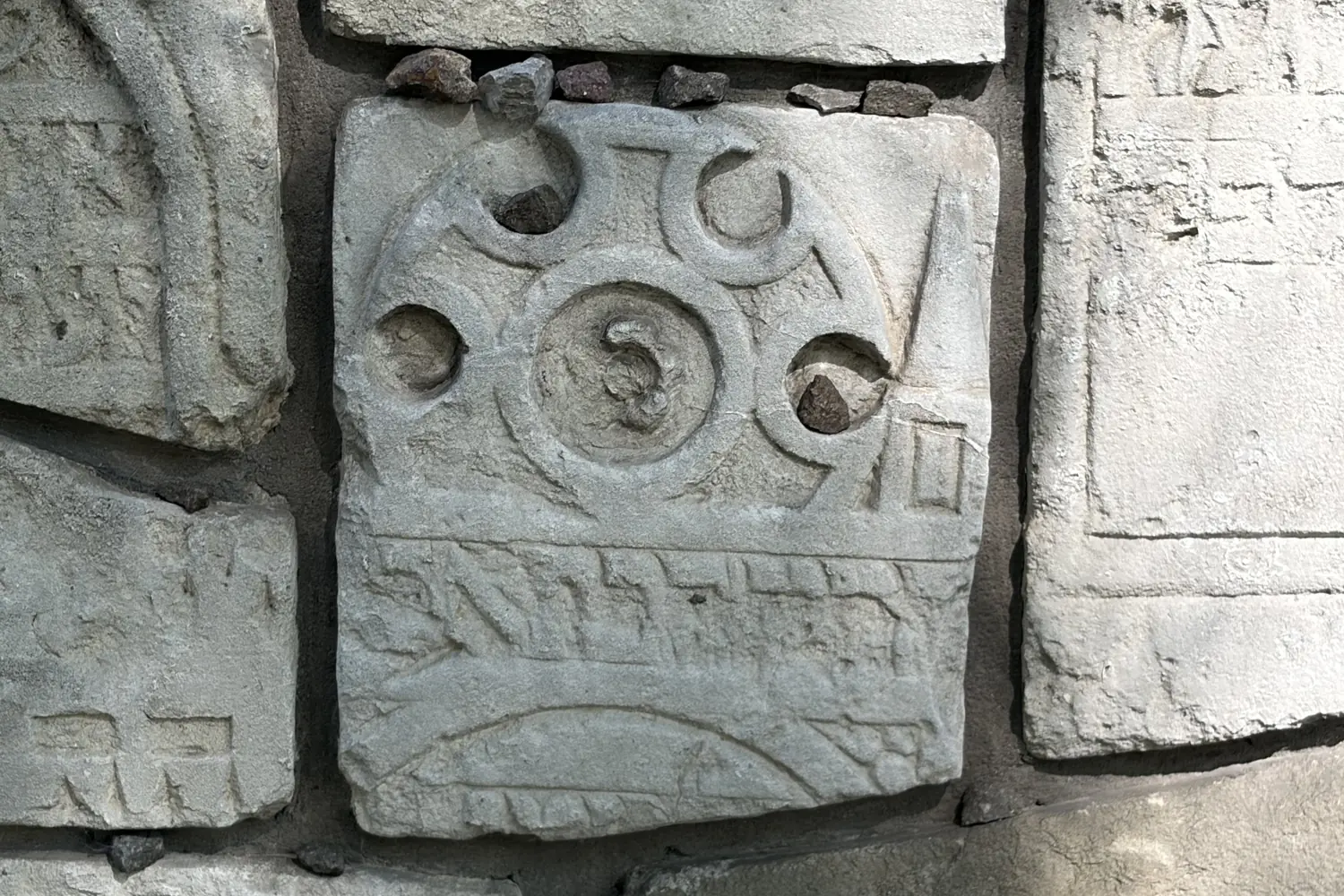 An ornamental matzevah detail - a rosette with a Hebrew inscription, Remah Cemetery in Kazimierz